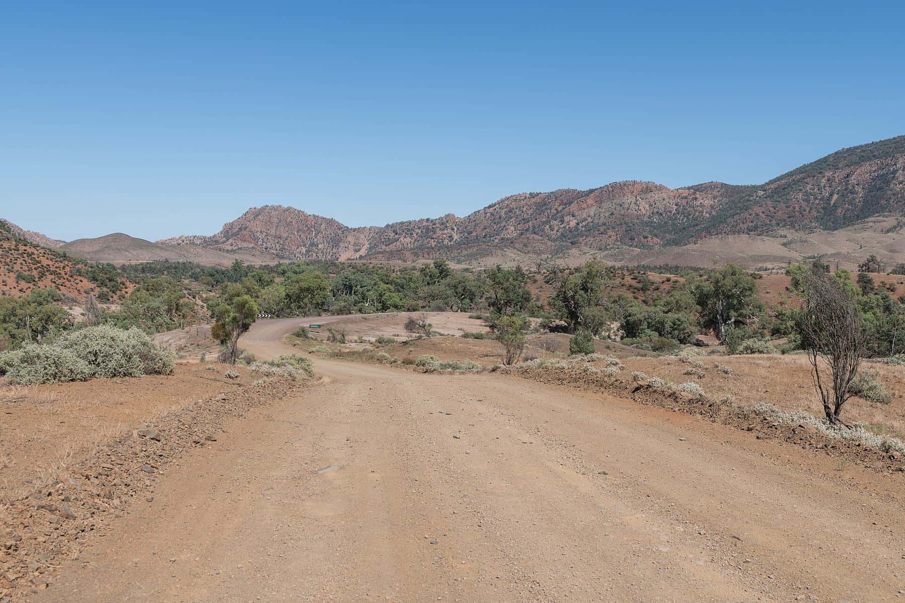 An unsealed road winding through Brachina Gorge in the Flinders Ranges